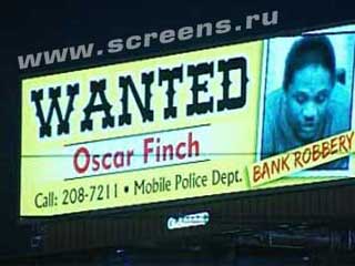 Announcement on outdoor digital LED sign about wanted criminals