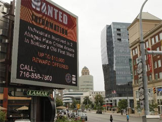 LED billboard in Buffalo with an notice seeking information on Old First Ward fires