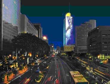 The Grand Indonesia Tower shines brightly along the main boulevard in Jakarta
